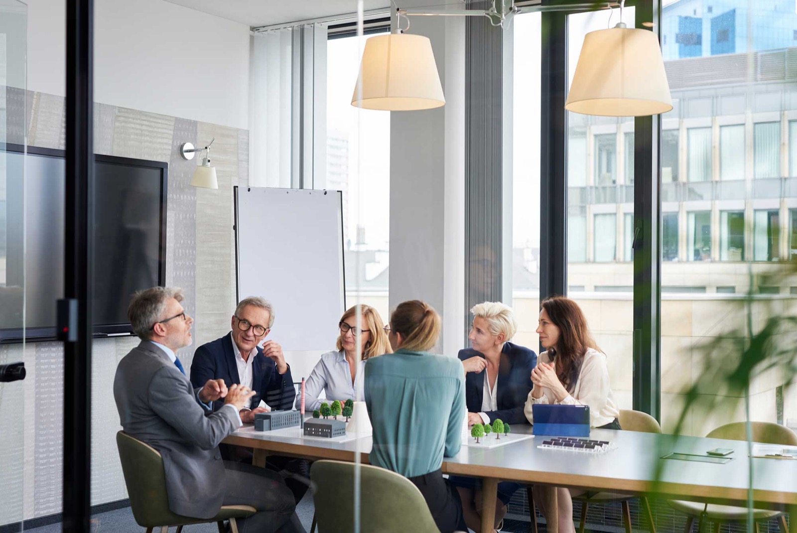 The Wealth Ease team meeting with clients in a conference room